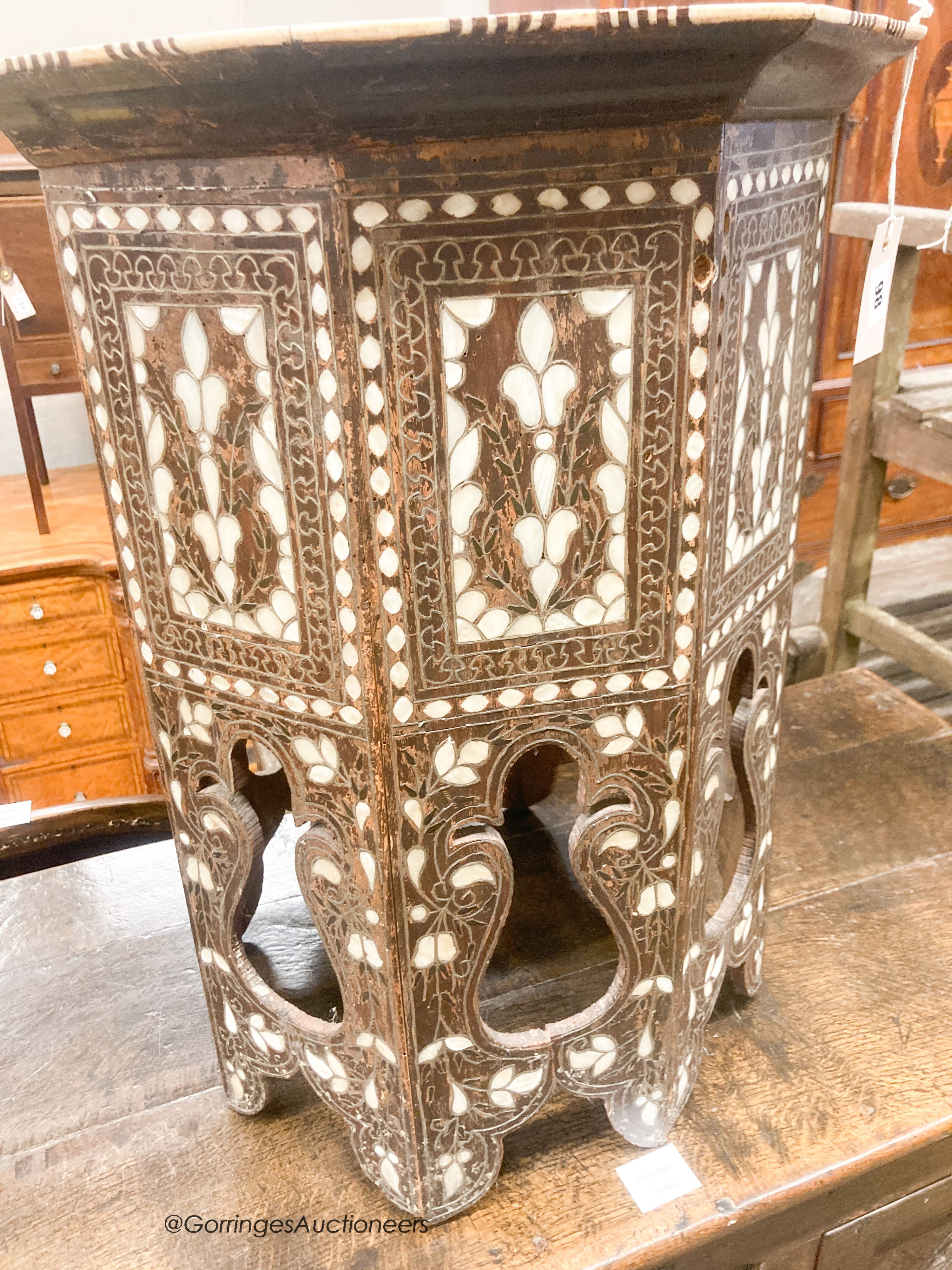 A Middle Eastern mother of pearl and bone inlaid octagonal topped coffee table, width 45cm, height 60cm